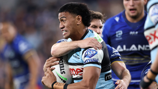 Ronaldo Mulitalo of the Sharks is tackled by Mitchell Moses of the Eels.