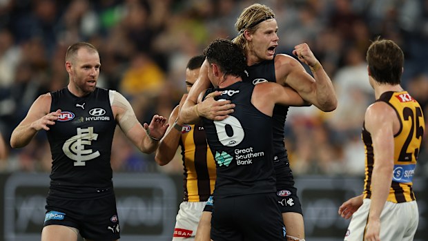 Carlton's Tom De Koning celebrates a goal with teammate Zac Williams.