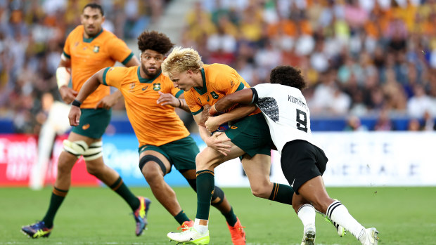 Carter Gordon of Australia is tackled by Simione Kuruvoli of Fiji.