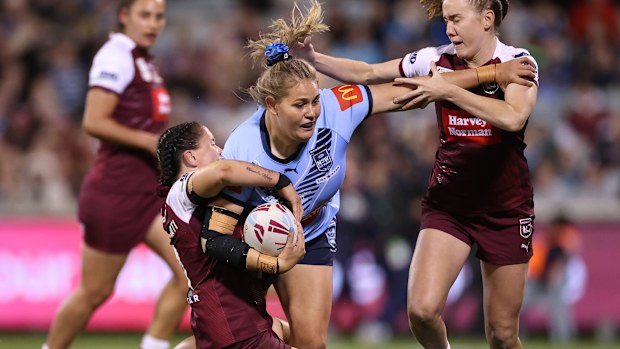 Caitlan Johnston of the Blues is tackled.