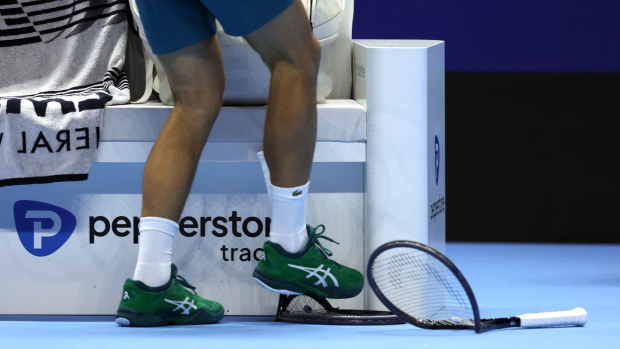 Novak Djokovic stamps on a racket in his opening match at the 2023  ATP Finals.