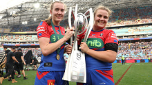 Tamika Upton and Hannah Southwell with the NRLW premiership trophy.