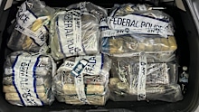 Police seized the cocaine, wrapped in plastic blocks, and replaced it with a substitute.