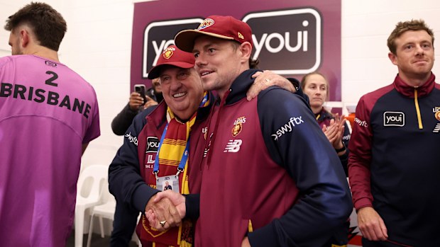 Lachie Neale of the Lions celebrates in the rooms.