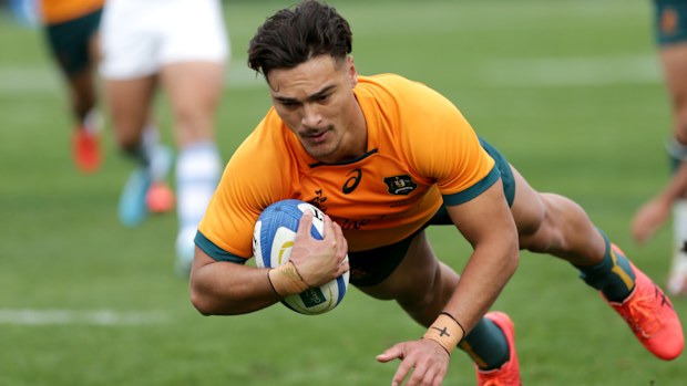 Jordan Petaia of Australia scores a try.