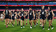 The Blues look dejected after a loss during the 2025 AFL Round 17 match between the Carlton Blues and the Collingwood Magpies