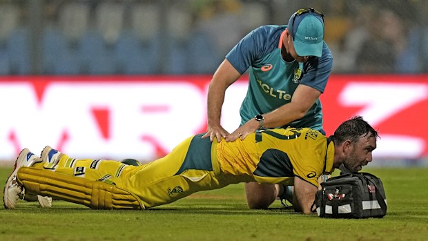 Australia's Glenn Maxwell is attended to during his record innings.