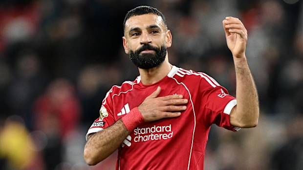 Mohamed Salah pats the Liverpool badge on his shirt after the Premier League win over Brighton.