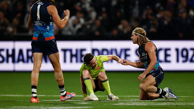 GEELONG, AUSTRALIA - MAY 22: Bailey Smith of the Cats helps Jacob Mollison, AFL Field Umpire to his feet during the 2025 AFL Round 11 match between the Geelong Cats and the Western Bulldogs at GMHBA Stadium on May 22, 2025 in Geelong, Australia. (Photo by Michael Willson/AFL Photos via Getty Images)