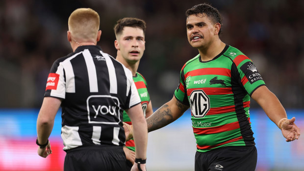 Latrell Mitchell of the Rabbitohs talks with referee Todd Smith during the Rabbitohs' round 23 match against the Sharks.