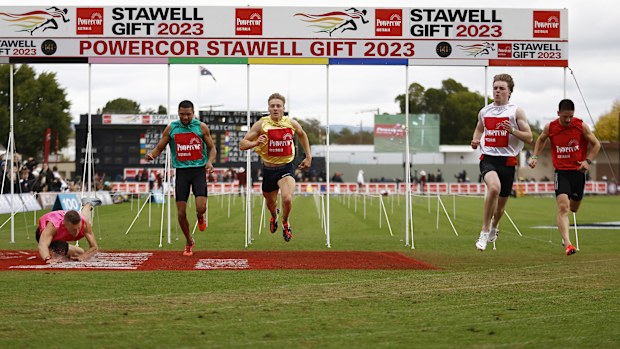 Ryan Tarrant (white bib) wins the men's 120-metre race at the 2023 Stawell Gift.