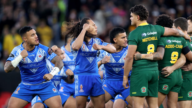 Players of Samoa face off with Latrell Mitchell of Australia during the Siva Tau prior to the Rugby League World Cup Final match between Australia and Samoa at Old Trafford on November 19, 2022 in Manchester, England. (Photo by Naomi Baker/Getty Images)