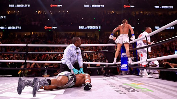 Jake Paul reacts to knocking out Tyron Woddley in the sixth round of their rematch fight.