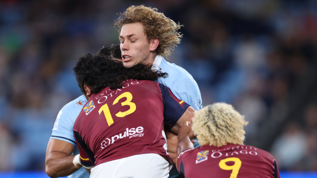 Ned Hanigan of the Waratahs is tackled.