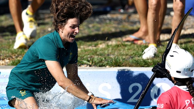 Jessica Fox of Team New Zealand jumps in the water to congratulate her sister Noemie Fox on winning gold 