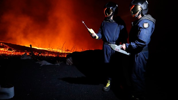 Military Emergency Unit personal take gas reading measurements near a volcano on the Canary island. 