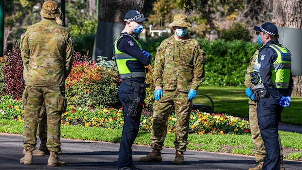 Australian Defence Force staff (ADF) and Victorian police are seen on patrol as a lockdown of Melbourne forces people to stay at home if not working, providing care or buying groceries.