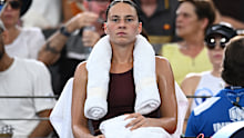 Marta Kostyuk of Ukraine rests in between games in her Brisbane final against Aryna Sabalenka.