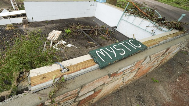 A Camp Mystic sign is seen near the entrance to the establishment along the banks of the Guadalupe River after a flash flood swept through the area in Hunt, Texas, Saturday, July 5, 2025. (AP Photo/Julio Cortez)