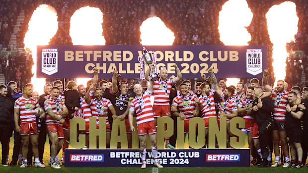 Liam Farrell of Wigan Warriors lifts the Betfred World Club Challenge trophy after the team's victory in the Betfred World Club Challenge match between Wigan Warriors and Penrith Panthers at DW Stadium on February 24, 2024 in Wigan, England. (Photo by Lewis Storey/Getty Images)