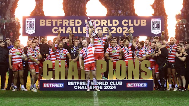 Liam Farrell of Wigan Warriors lifts the Betfred World Club Challenge trophy after the team's victory in the Betfred World Club Challenge match between Wigan Warriors and Penrith Panthers at DW Stadium on February 24, 2024 in Wigan, England. (Photo by Lewis Storey/Getty Images)