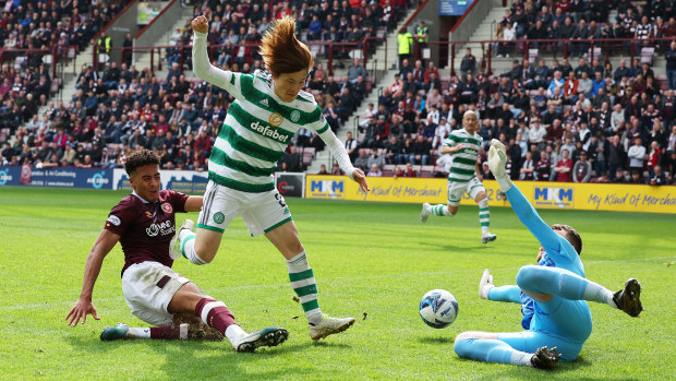 Kyogo Furuhashi of Celtic scores the team's first goal past Zander Clark of Heart of Midlothian during the Cinch Scottish Premiership match between Heart of Midlothian and Celtic FC at Tynecastle Park on May 07, 2023 in Edinburgh, Scotland. (Photo by Ian MacNicol/Getty Images)