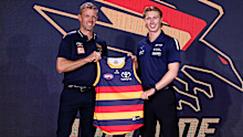 Sid Draper is presented his Adelaide jumper by Nathan Van Berlo after being snapped up with pick four.