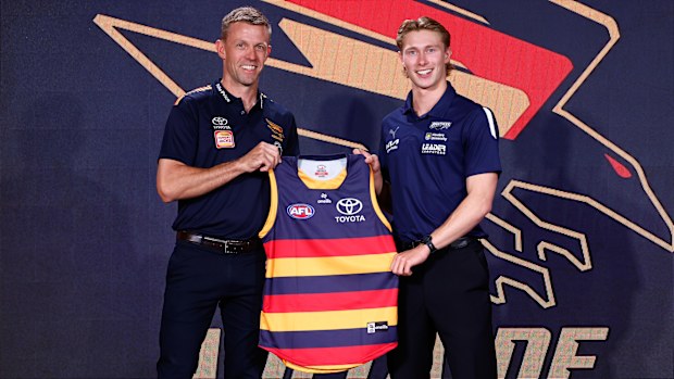 Sid Draper is presented his Adelaide jumper by Nathan Van Berlo after being snapped up with pick four.