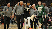Damian Lillard of the Milwaukee Bucks is helped off the court after an achilles injury during the first quarter in Game Four of the Eastern Conference First Round NBA Playoffs against the Indiana Pacers.