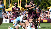 Cory Paix celebrate with his Broncos teammates after scoring a try.