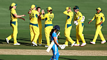 Australian players celebrate with Megan Schutt after she took a wicket.