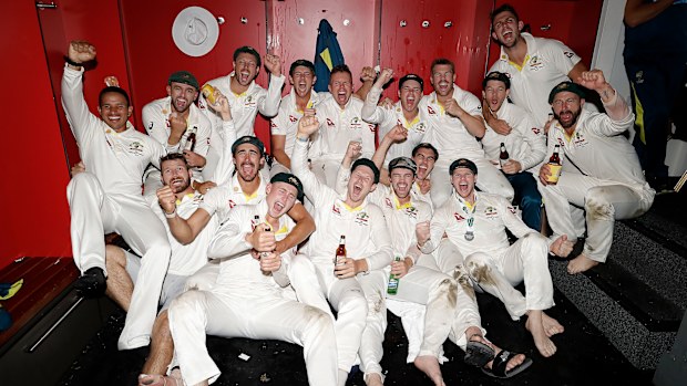 The Australian cricket team poses for a victory shot during celebrations in the dressing room.
