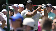 Tiger Woods watches his tee shot on the ninth hole during third round.