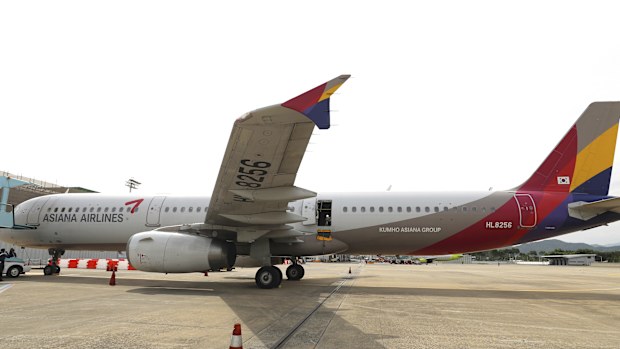 An Asiana Airlines plane is parked as one of the plane's doors suddenly opened at Daegu International Airport in Daegu, South Korea, Friday, May 26, 2023. 