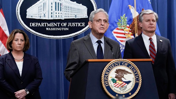 Attorney General Merrick Garland, centre, flanked by Deputy Attorney General Lisa Monaco, left, and FBI Director Christopher Wray, speaks to reporters as they announce charges against two men suspected of being Chinese intelligence officers for attempting to obstruct a US criminal investigation and prosecution of Chinese tech giant Huawei.