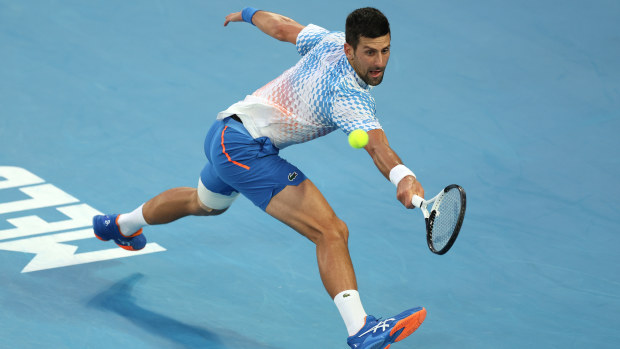 Novak Djokovic plays a backhand.