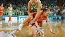 Jess Anstiss of the Fever and Madeline Hay of the Giants fall to the ground during their round 13 match-up.