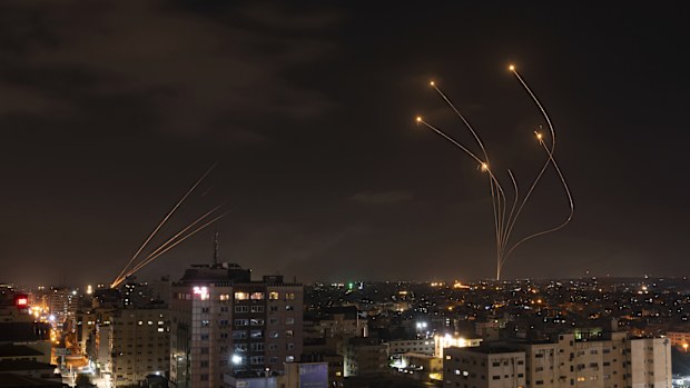 FILE - Rockets fired from Gaza and intercepted by Israel's Iron Dome anti-missile system over Israeli skies are seen from Gaza City, on May 13, 2023
