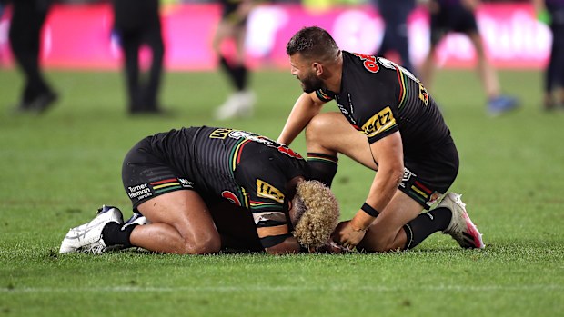 Viliame Kikau is comforted by Josh Mansour.