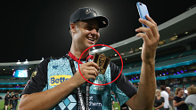 Brisbane Heat player Spencer Johnson shows off his KFC 'player of the match' medal after the BBL final.