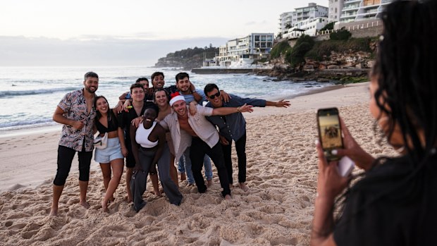 Friends celebrate Christmas at sunrise on Bondi Beach in Sydney.