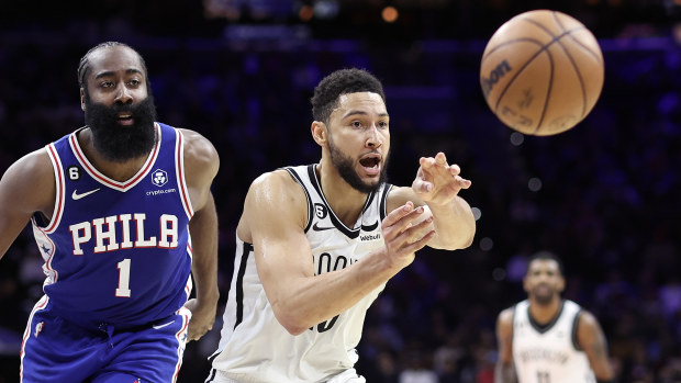 Ben Simmons of the Brooklyn Nets passes past James Harden.