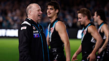 Ken Hinkley, coach of the Power, exchanges words with Hawthorn players.