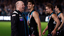 Power coach Ken Hinkley sprays Hawks players after their final.