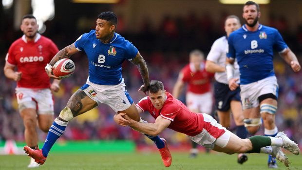 Monty Ioane of Italy breaks away from the tackle of Gareth Davies of Wales.