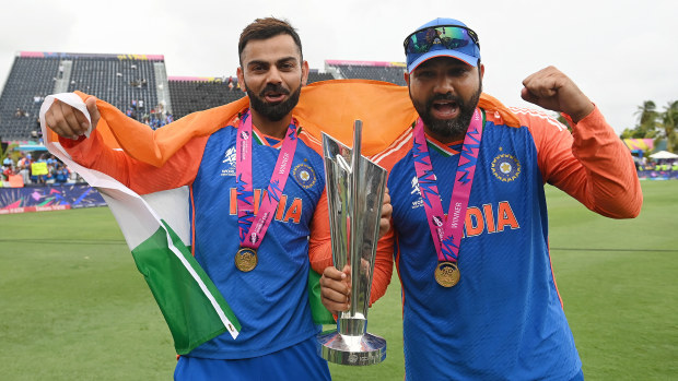 Virat Kohli (L) and Rohit Sharma hold the trophy after India won the ICC Men's T20 Cricket World Cup West Indies & USA 2024 Final match between South Africa and India at Kensington Oval on June 29, 2024 in Bridgetown, Barbados. (Photo by Philip Brown/Getty Images)