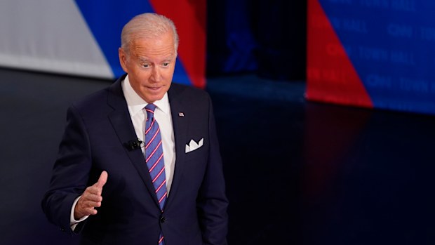 President Joe Biden participates in a CNN town hall at the Baltimore Center Stage Pearlstone Theater, Thursday, Oct. 21, 2021, in Baltimore, with moderator Anderson Cooper. (AP Photo/Evan Vucci)