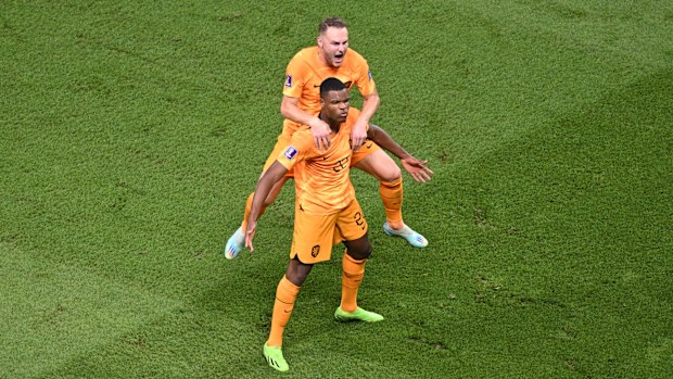 Denzel Dumfries of Netherlands celebrates after scoring the team's third goal with teammate Teun Koopmeiners during the FIFA World Cup Qatar 2022 Round of 16 match between Netherlands and USA at Khalifa International Stadium on December 03, 2022 in Doha, Qatar. (Photo by Shaun Botterill - FIFA/FIFA via Getty Images)