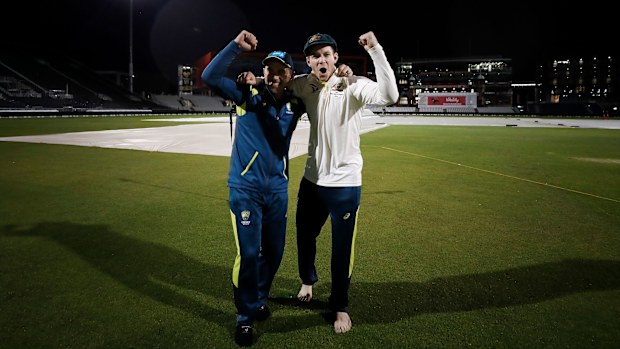 Captain Tim Paine and coach Justin Langer embrace on the Old Trafford turf.