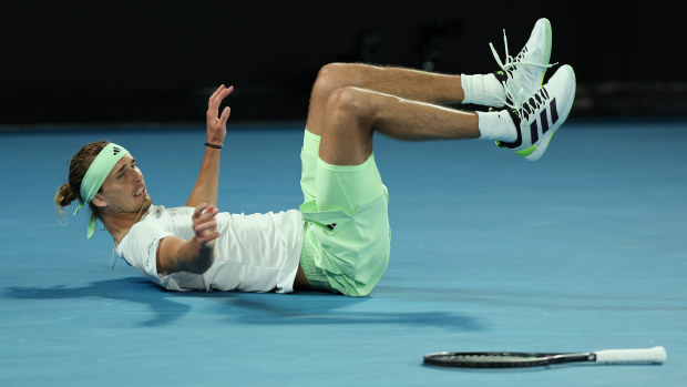 Alexander Zverev of Germany falls over attempting to play a shot during their quarter-finals singles match against Carlos Alcaraz.